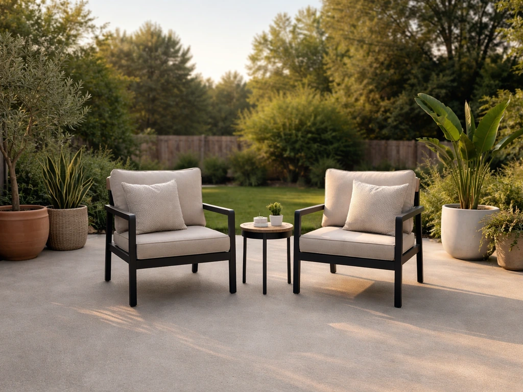 Uncovered concrete patio with a small seating set in a quiet backyard setting